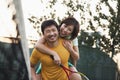 Boyfriend holding his girlfriend next to the tennis net Royalty Free Stock Photo