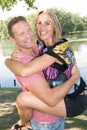 Boyfriend man carrying his girlfriend woman on front piggyback meeting in the park Royalty Free Stock Photo