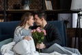 boyfriend presenting bouquet of roses to happy girlfriend