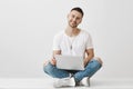 Boyfriend wants to show his couple something in laptop. Portrait of good-looking young bearded student in stylish