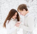 Boyfriend warms hands sweetheart, frozen in the cold Royalty Free Stock Photo