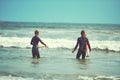 Boyfriends make the best surfing buddys. a young couple surfing at the beach. Royalty Free Stock Photo