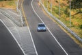 Blue color Honda jazz or Honda fit driving fast on trans jawa highway blurry in motion Royalty Free Stock Photo