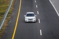 White Toyota Vios driving fast on trans jawa highway