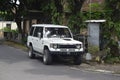 White Mitsubishi Pajero first generation parked on the side of the road