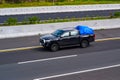 Black Toyota Hilux double cabin truck driving fast on trans jawa highway toll road Royalty Free Stock Photo