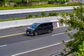 Black Toyota voxy driving fast on trans jawa highway