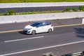 White Toyota Yaris hatchback XP130 driving fast on trans jawa highway