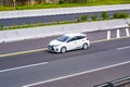 White Toyota Yaris hatchback XP130 driving fast on trans jawa highway