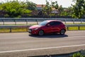 Red Mazda2 or Mazda demio on trans jawa highway