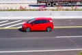 Red Honda Jazz or known as Fit Gk5 speeding on trans Java Highway Royalty Free Stock Photo