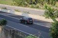 Black BMW X3 G01 driving fast on trans jawa highway