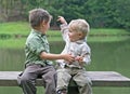 Boys on a bench at the pond Royalty Free Stock Photo