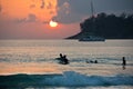 Boys on boards in sunset Royalty Free Stock Photo