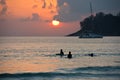 Boys on boards in sunset Royalty Free Stock Photo