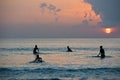 Boys on boards in sunset Royalty Free Stock Photo