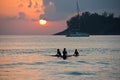 Boys on boards in sunset Royalty Free Stock Photo