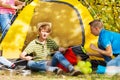 Boys build yellow tent themselves at camping site