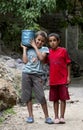 Boys carrying a gas cylinder in the mountain town of Imlil, Morocco.