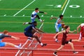 Boys competing in hurdles at a Track Competition