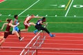 Boys competing in hurdles at a Track Competition