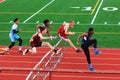 Boys competing in hurdles at a Track Competition Royalty Free Stock Photo