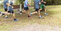 Boys cross country team running in a park Royalty Free Stock Photo