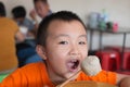 Boys eating big meatballs Royalty Free Stock Photo