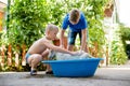 Boys enjoying washing their dog Royalty Free Stock Photo