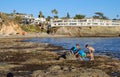Boys exploring tide pool in Laguna Beach, California