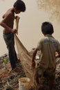 Boys fish with a hand cast net