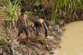 Boys fish with a hand cast net