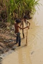 Boys fish with a hand cast net