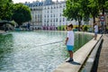 Boys fish on the side of Canal Staint-Martin in Paris