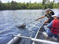 Boys fishing in a canoe catch a walleye Royalty Free Stock Photo