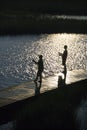 Boys fishing on dock. Royalty Free Stock Photo