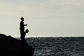 Boys fishing from rocky shore