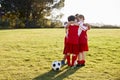 Boys in a football team talking in team huddle before game Royalty Free Stock Photo