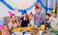 Boys and girls behaving jokingly during friend birthday party