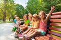 Boys and girls on the bench in park Royalty Free Stock Photo