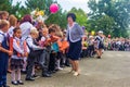 Boys and girls are enrolled in first grade and receive gifts from high school students on the solemn line at the school on Knowled