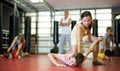 Boys and girls in gym exercising armlock move