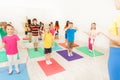 Boys and girls jumping with skipping rope in gym