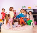 Boys and girls listen to teacher read book Royalty Free Stock Photo