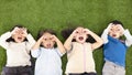 Boys and girls lying on green grass Royalty Free Stock Photo