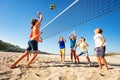 Boys and girls playing volleyball on the beach Royalty Free Stock Photo