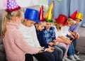 Boys and girls spending time playing with smartphones Royalty Free Stock Photo