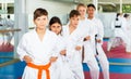 Boys and girls are studying karate technique in gym