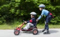 Boys gokart and roller blades Royalty Free Stock Photo