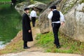 3 boys, Hasidic Jews family , in black traditional clothes walk in the park in Uman, Ukraine